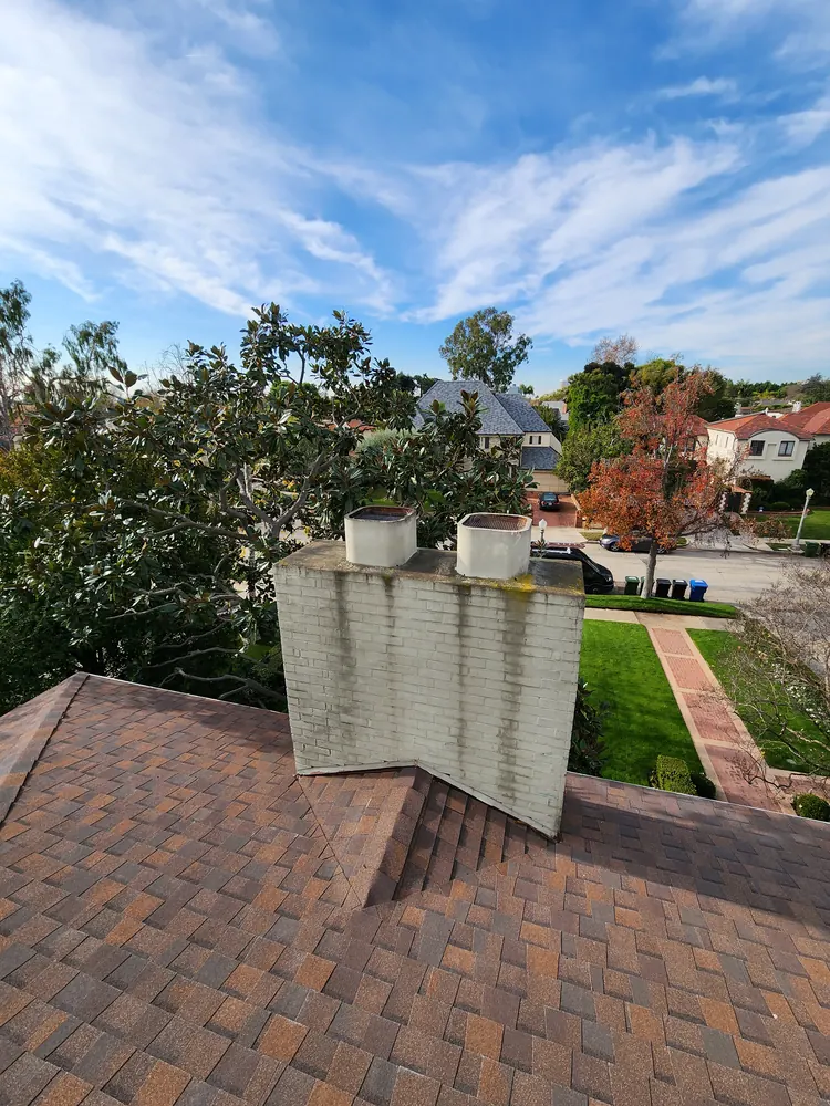 Residential chimney photographed during a rooftop assessment