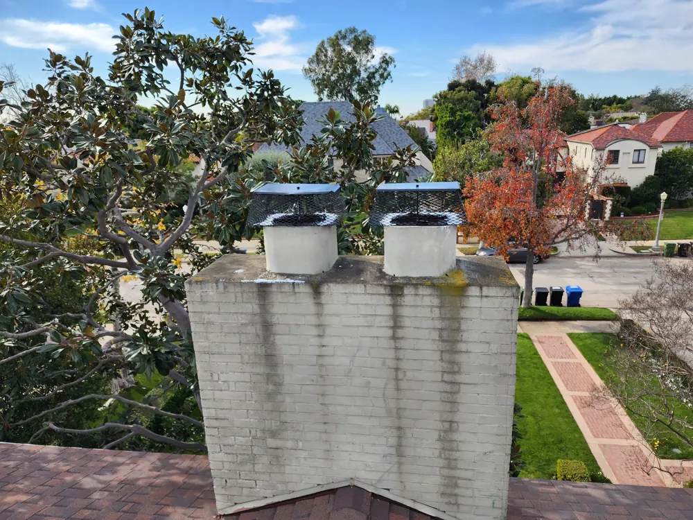 Closer view of the double-flue chimney and chimney-top components